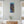 Load image into Gallery viewer, Colours of Home canvas by Adam Young between two windows in a bright living room
