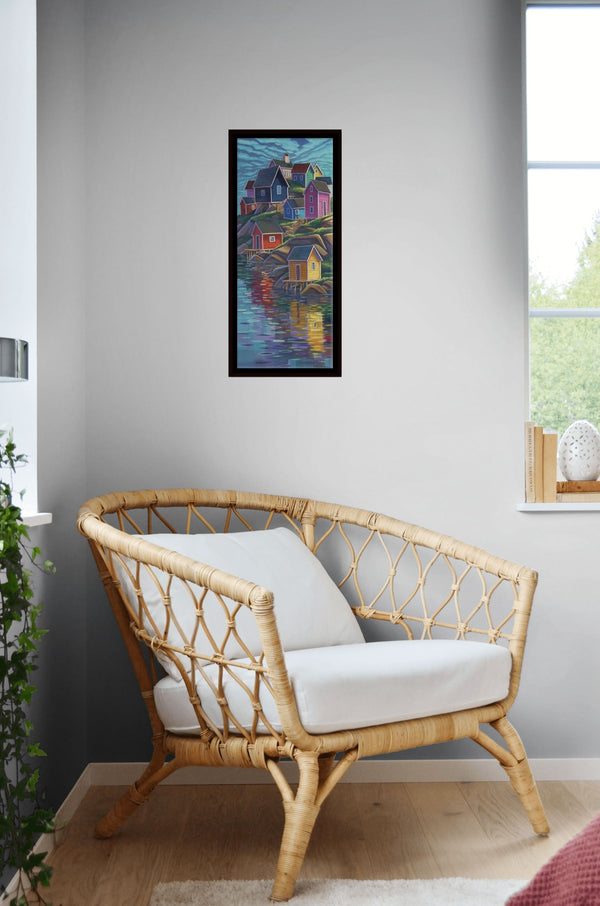 Colours of Home by Adam Young framed beside a rattan armchair