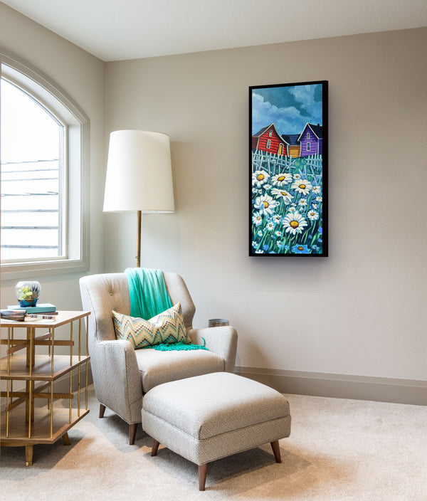Daisies by Adam Young framed in a bright reading nook beside a floor lamp, armchair and ottoman