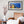 Load image into Gallery viewer, Bright Little Town framed paper print shown in a room setting
